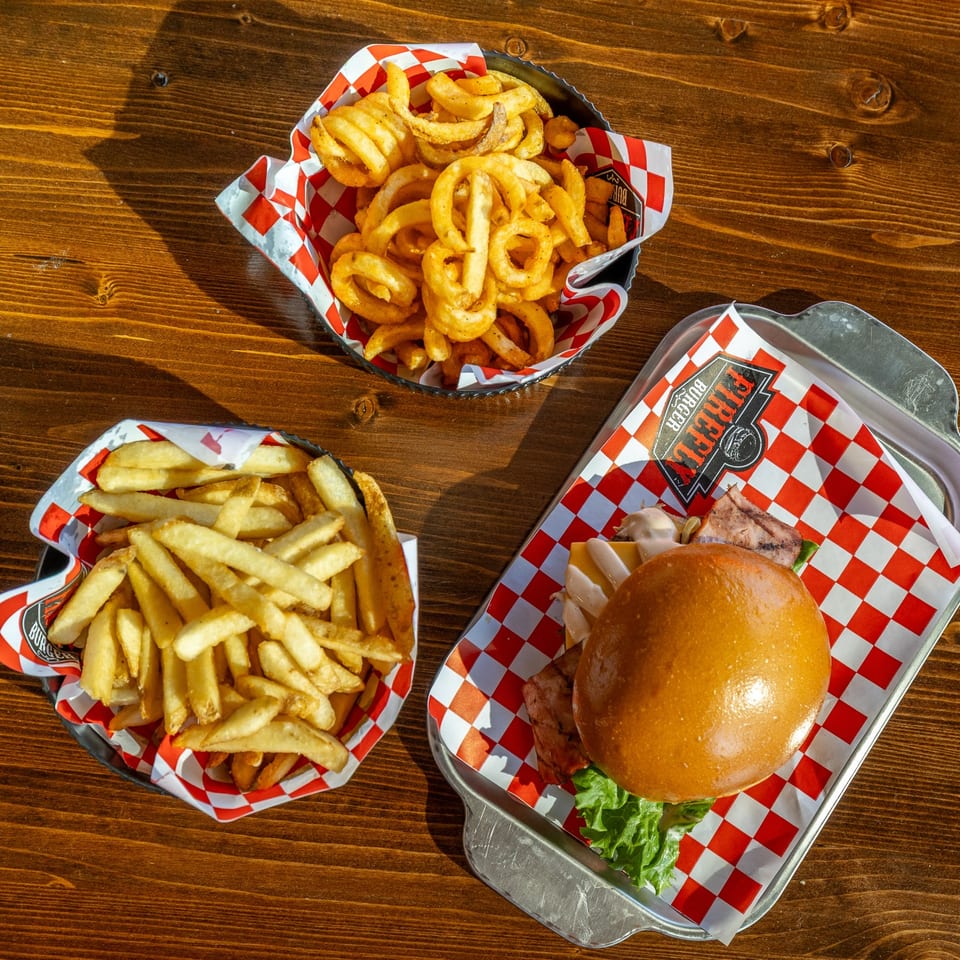 Burger served with two baskets of fries