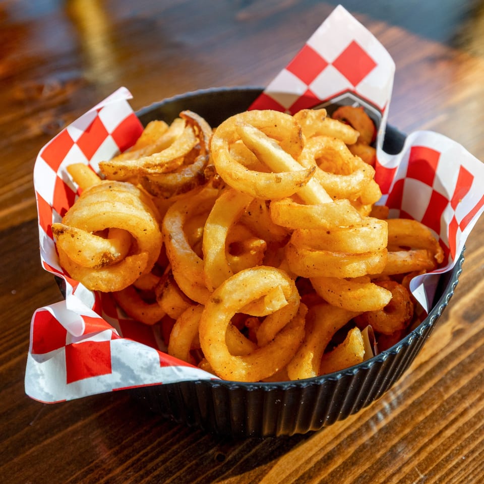 Curly fries on checkered paper